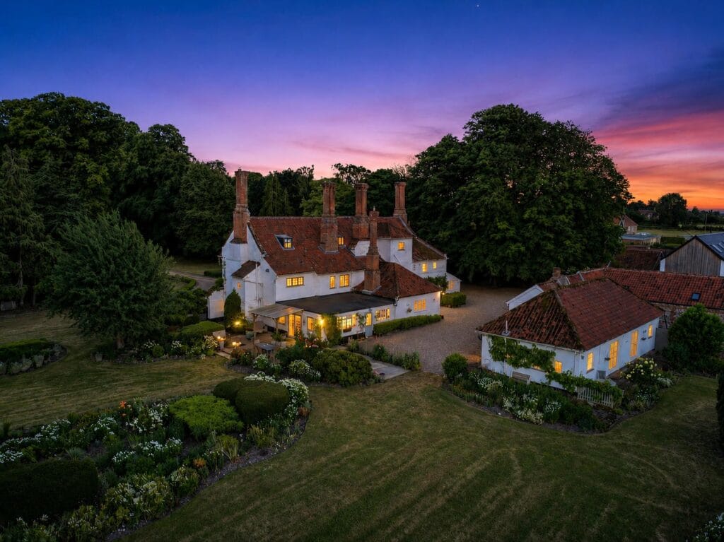 Aerial twilight view of Bury's Hall, Ashill, with glowing sunset sky