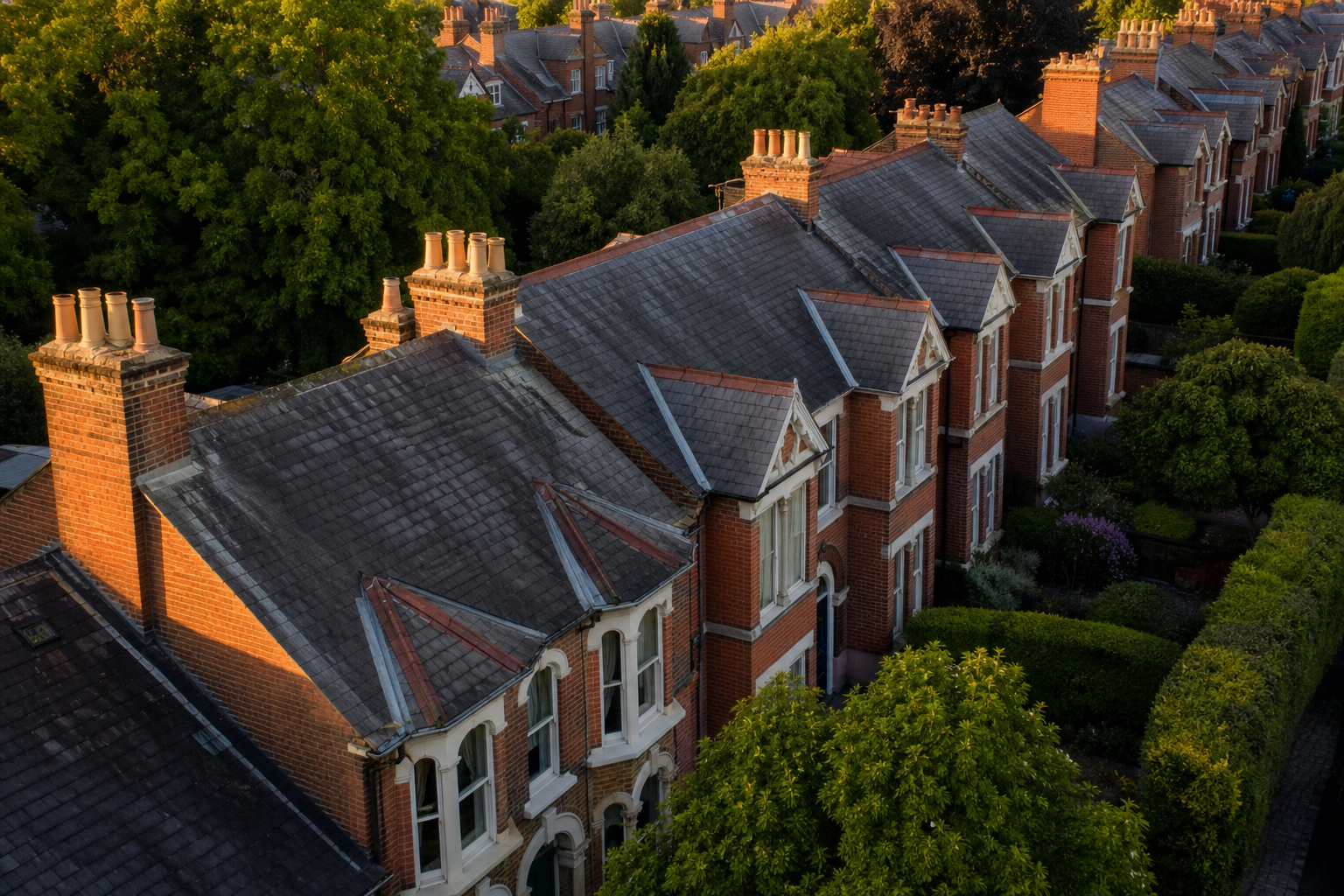 Row of Victorian terraced houses in golden evening light across an English market town