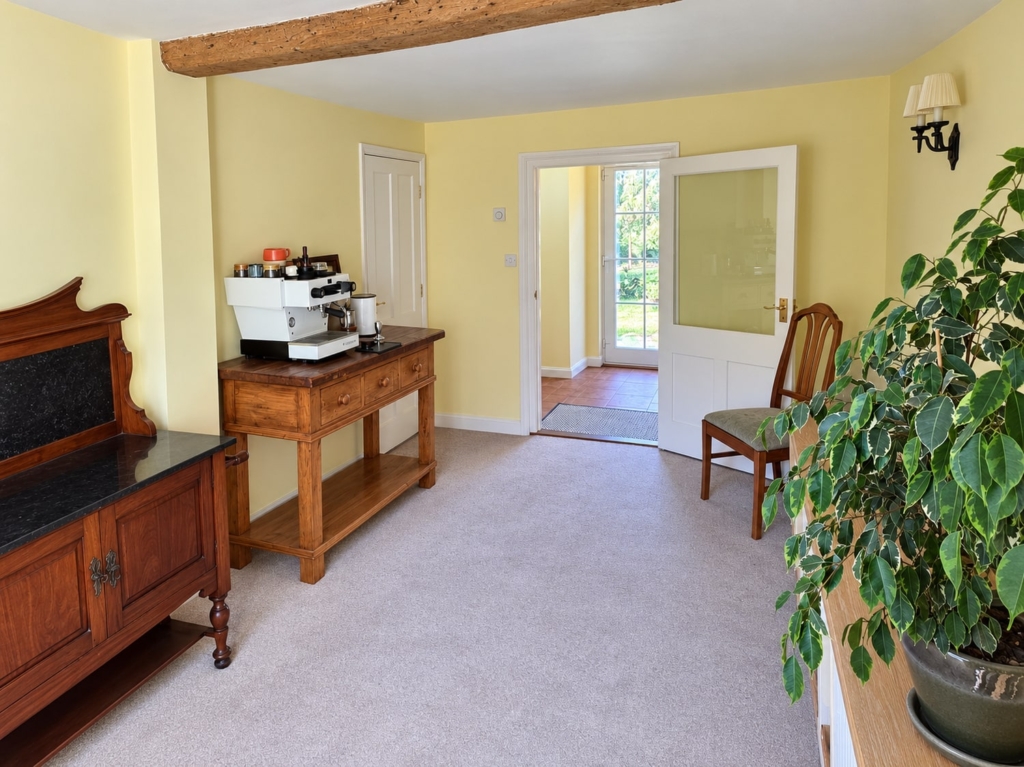 Reception hall with antique sideboard and door to the garden in Loddon Hall Cottage, Norfolk