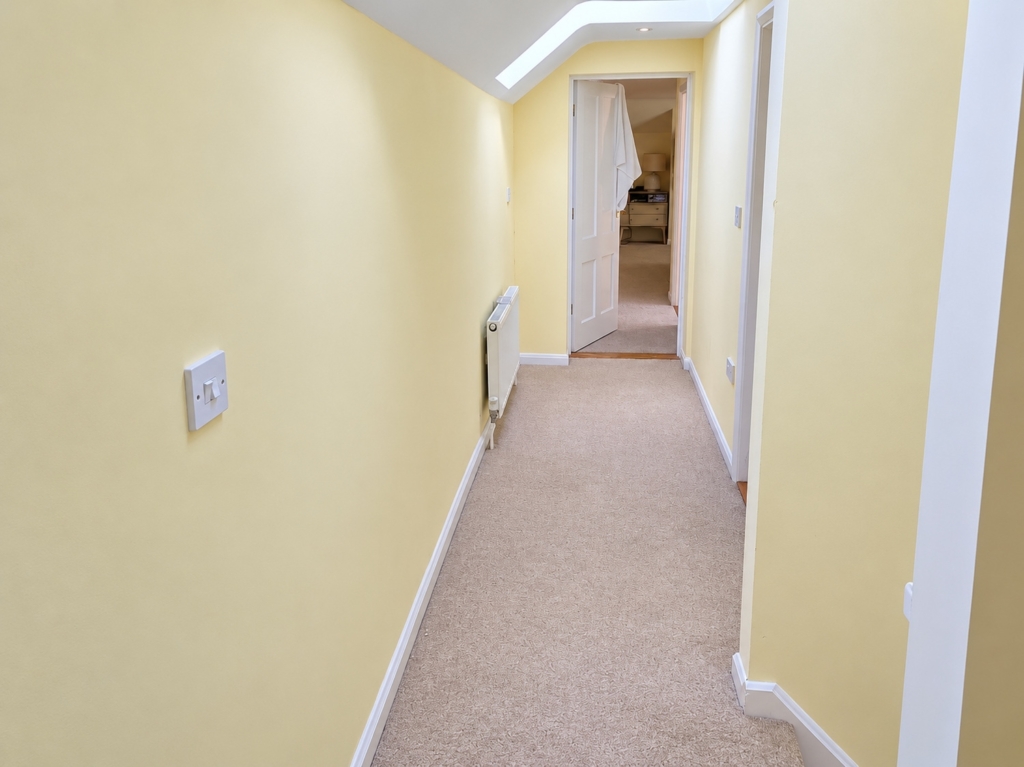 Carpeted corridor with skylight in Loddon Hall Cottage, Norfolk