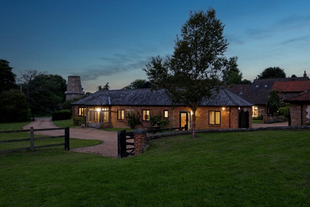 A view of the Kitchen and Annexe from the Garden at dusk