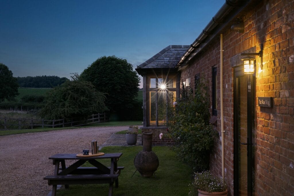Seating area outside the Annexe and kitchen at dusk