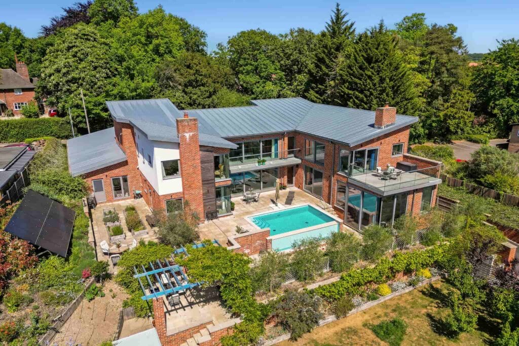 An architectural masterpiece nestled in verdant gardens, with sun-drenched terraces and a sparkling pool creating the perfect setting for leisurely days and elegant evenings.