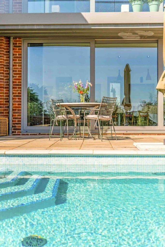 Poolside table set with fresh flowers for leisurely moments in the sun.
