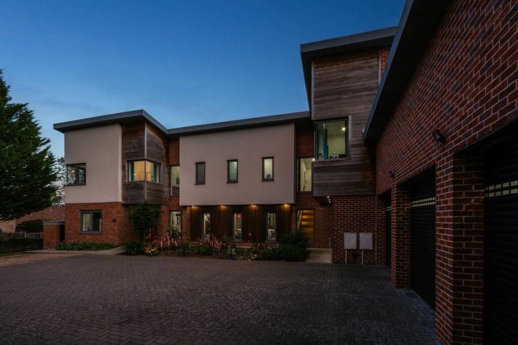 Evening glow enhances the striking architecture, creating an inviting and sophisticated entrance.