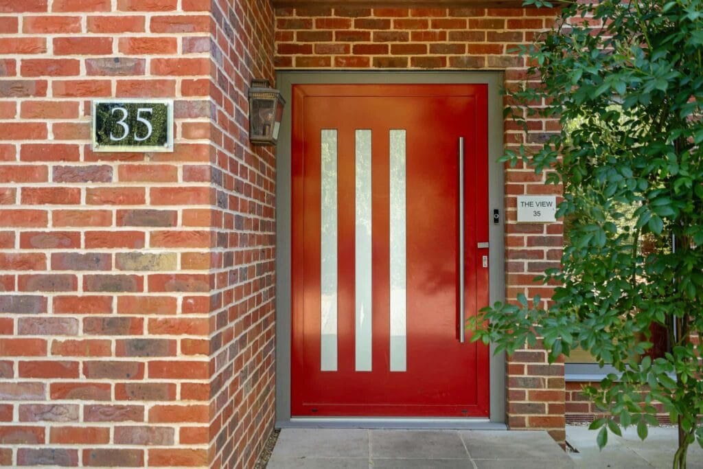 Striking contemporary front door offering a bold, stylish welcome into this exceptional home.