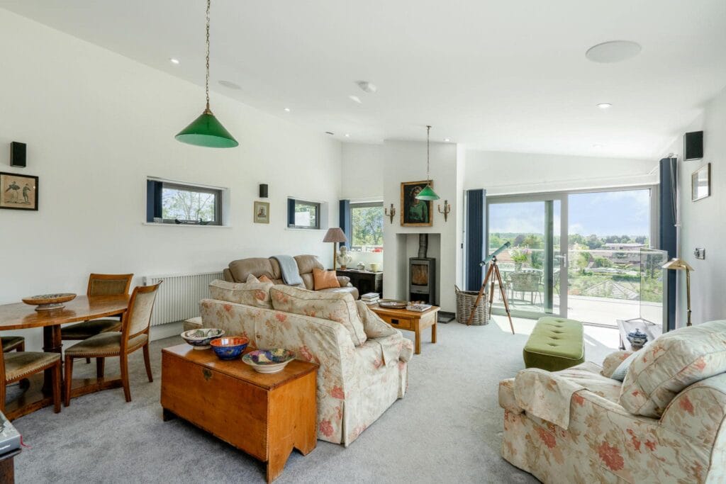 Spacious upstairs living room with balcony and panoramic views.
