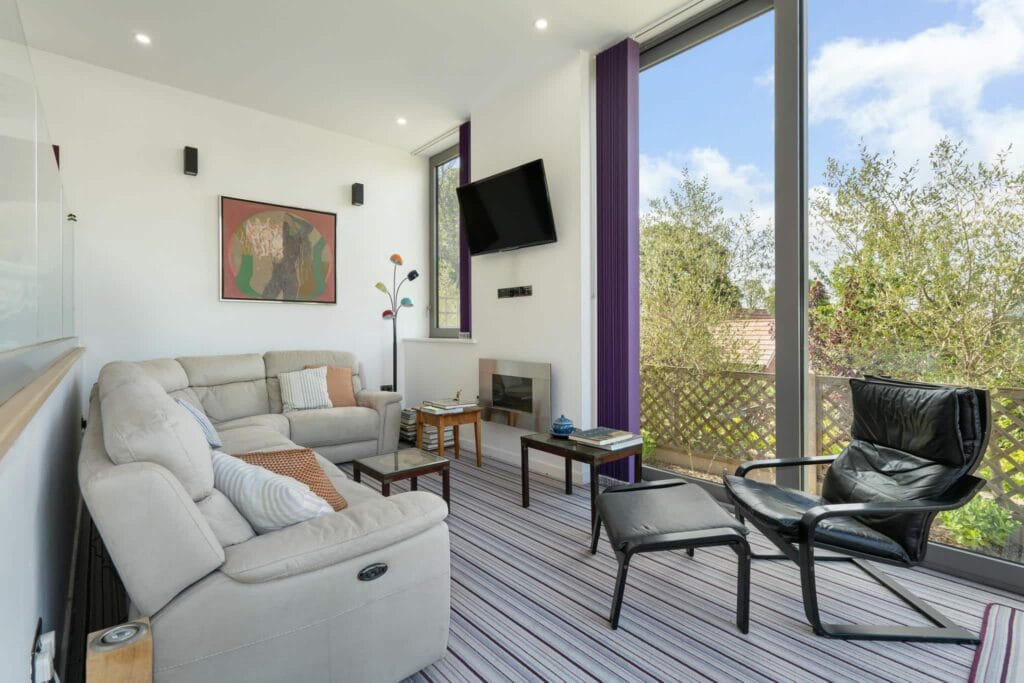 Bright snug with garden views and feature fireplace.
