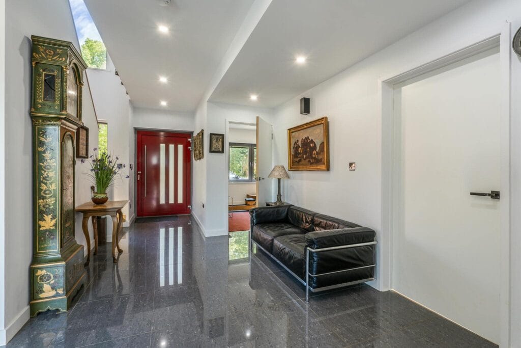 Elegant entrance hall with high-gloss floors and designer touches, setting a luxurious tone for the home.