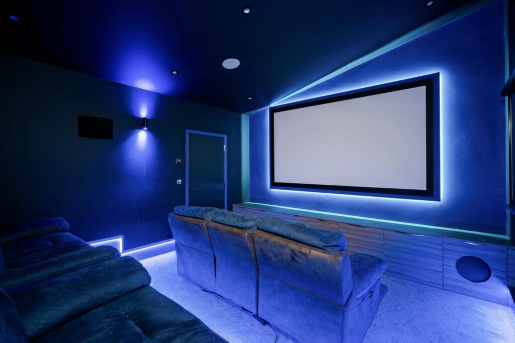 Private cinema with plush tiered seating and ambient lighting for an unforgettable at-home movie experience.