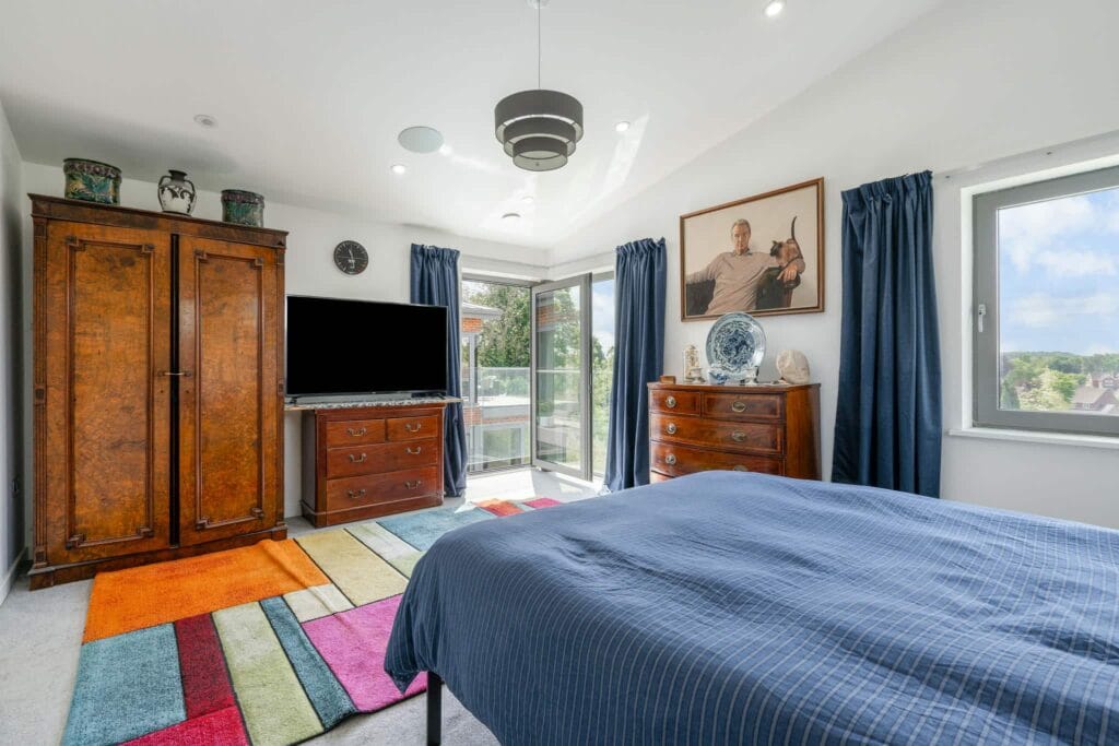 Bright guest bedroom with rear views
