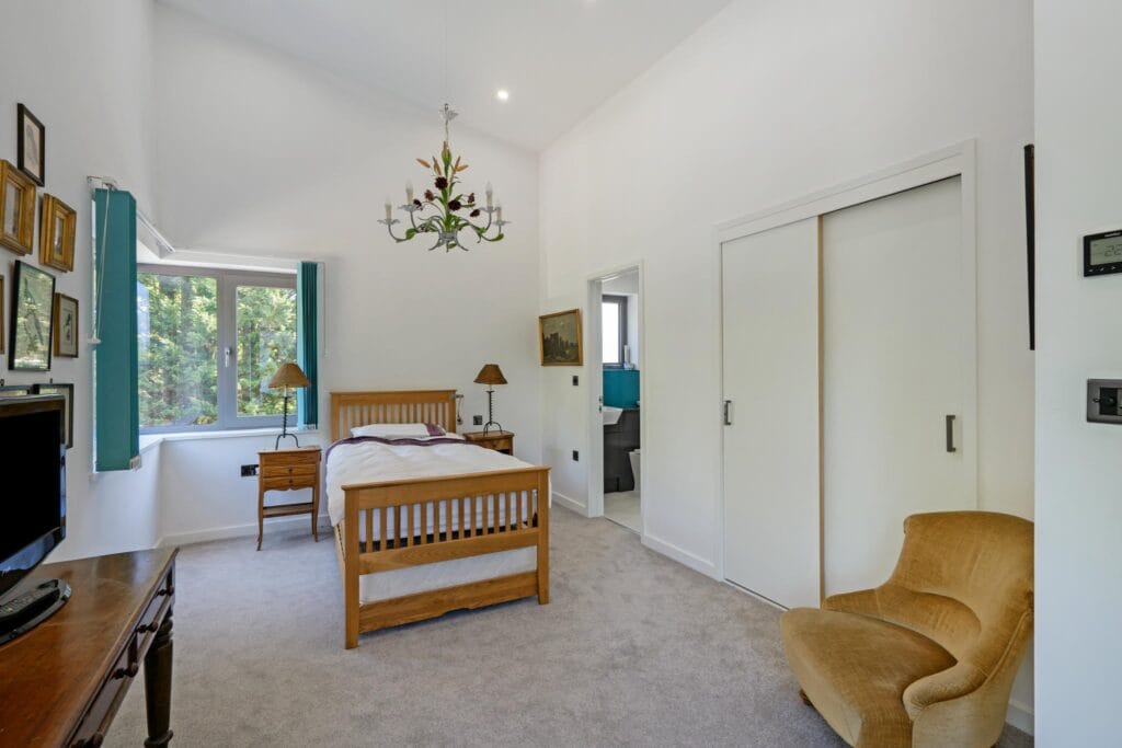Light-filled guest bedroom with triple aspect and ensuite.