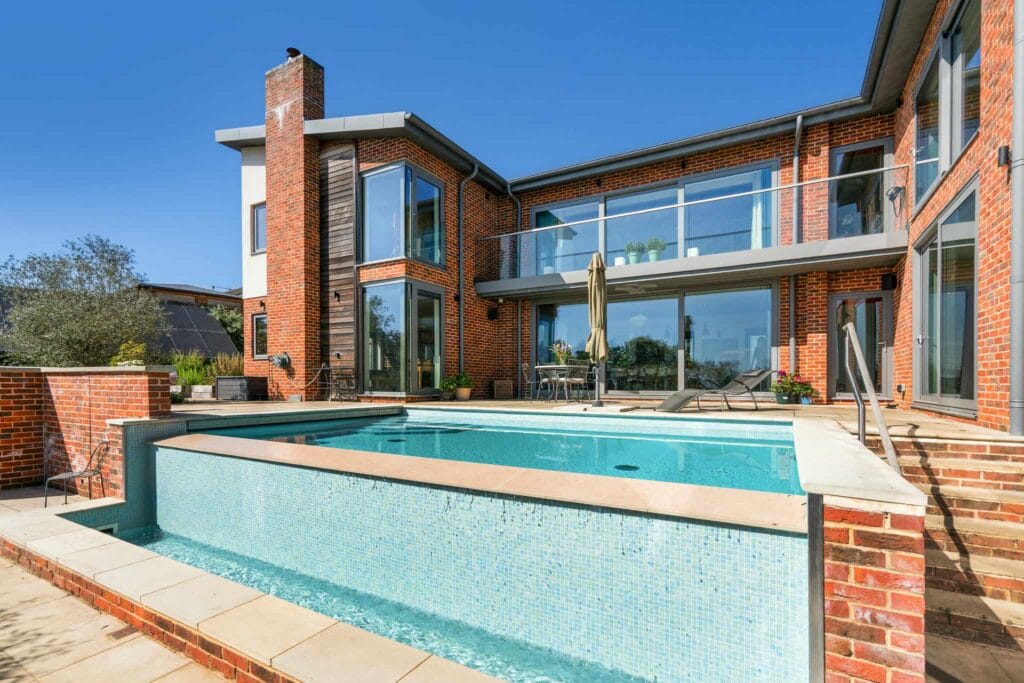 Glittering infinity-edge pool framed by sun-warmed terraces, inviting you to unwind in absolute luxury.