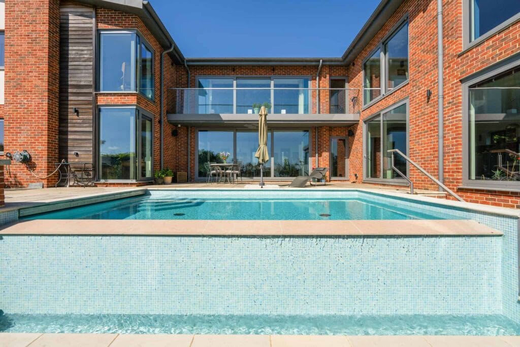 Central courtyard pool framed by contemporary brick architecture.