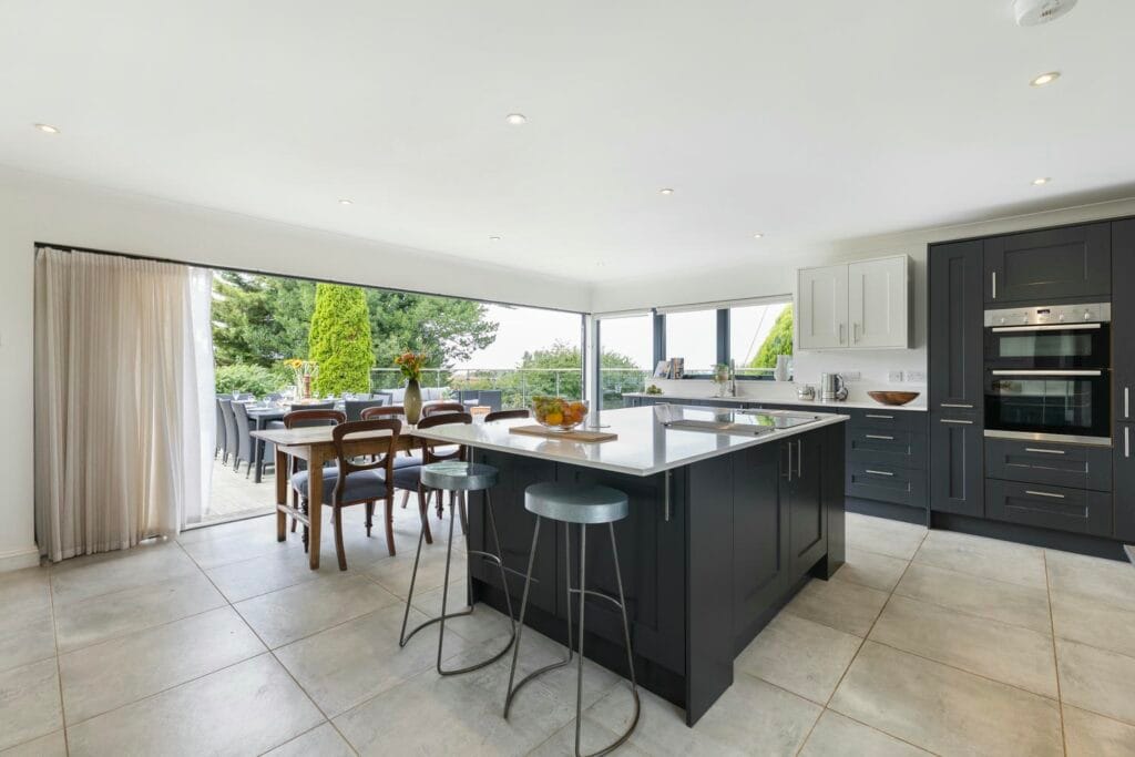 Contemporary kitchen opening to terrace dining