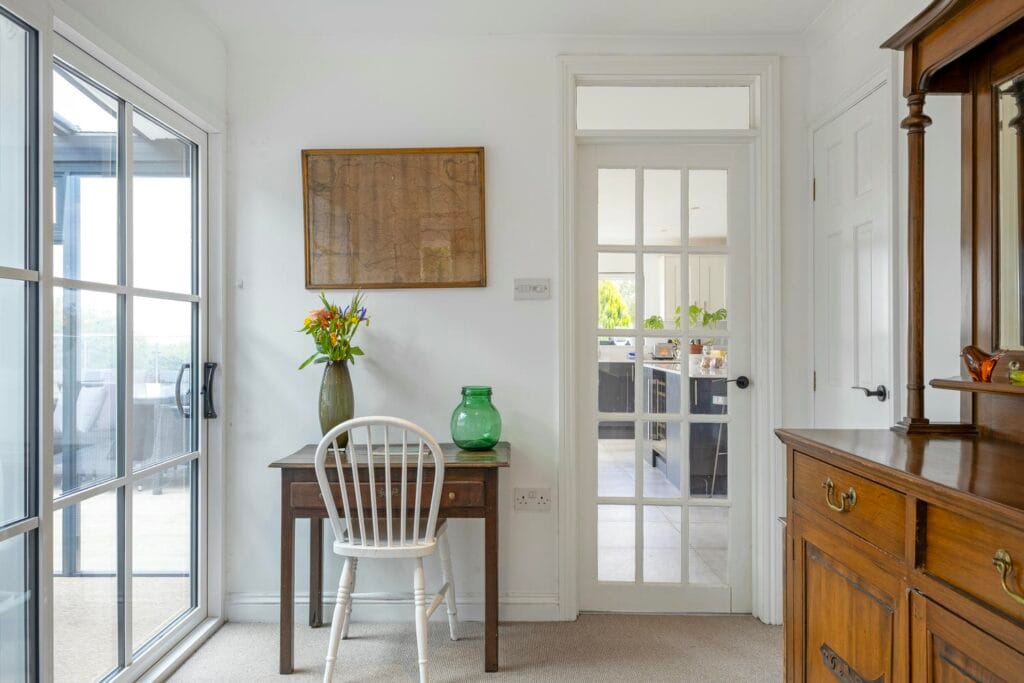 Hallway with access to kitchen, sunroom, living areas and bedrooms