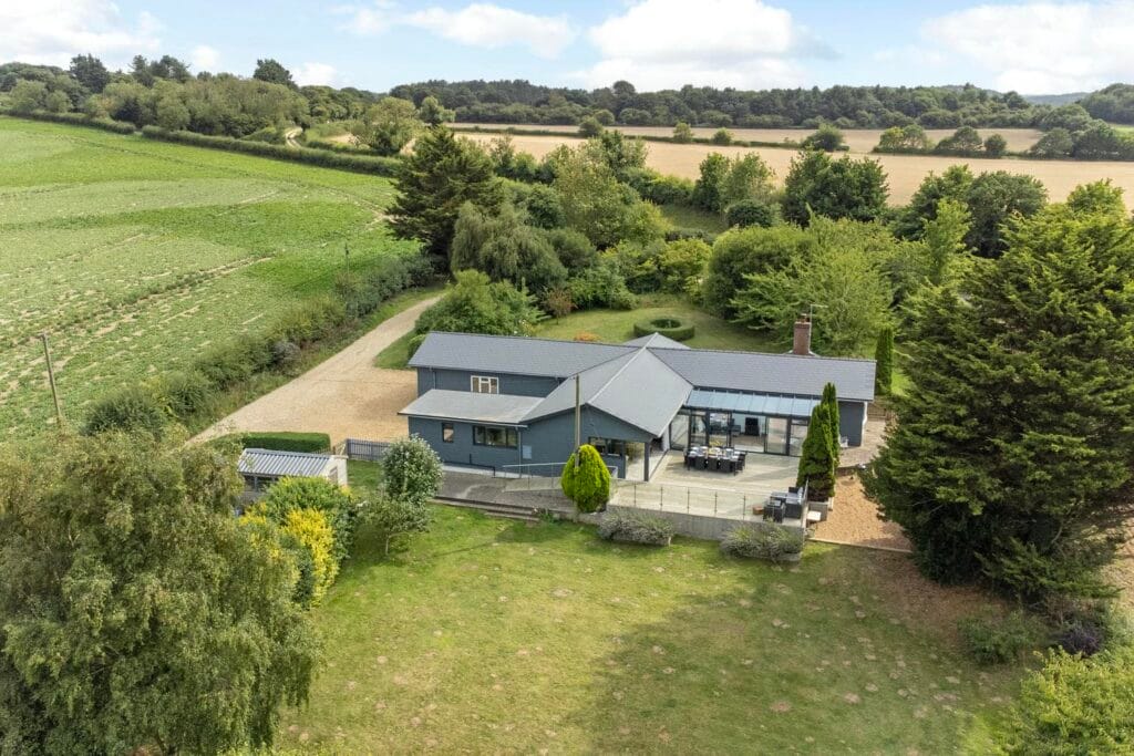 Rear view of Rectory Hill Cottage with terrace and surrounding gardens