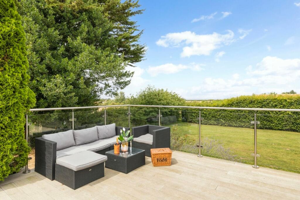 Relaxed terrace seating with the sea in the distance