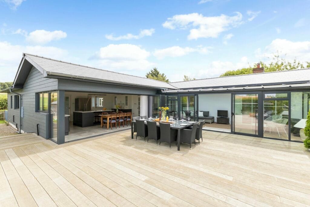 Kitchen, sun room and terrace dining stylishly connected