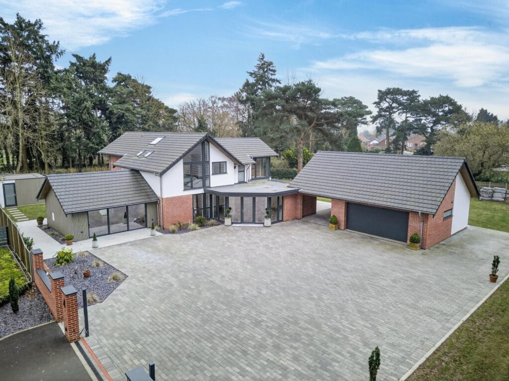 Luxury detached house with expansive block paved driveway, double garage and contemporary architecture.