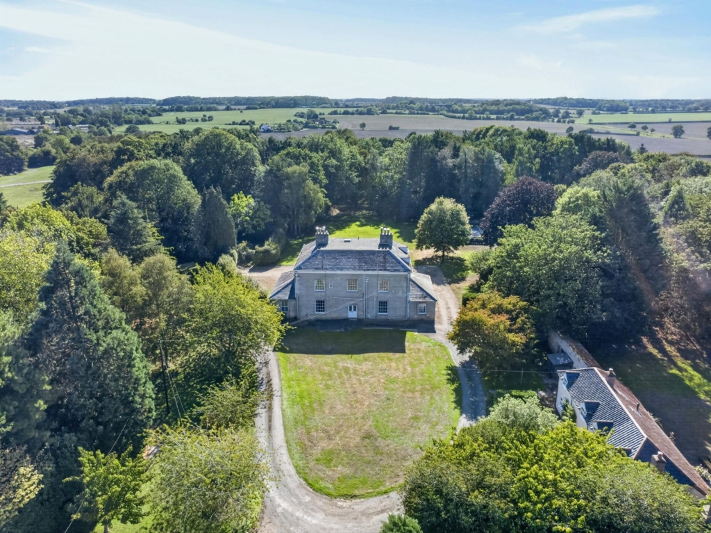 Drone view of Loddon Hall with its gravel drive and mature grounds, Norfolk