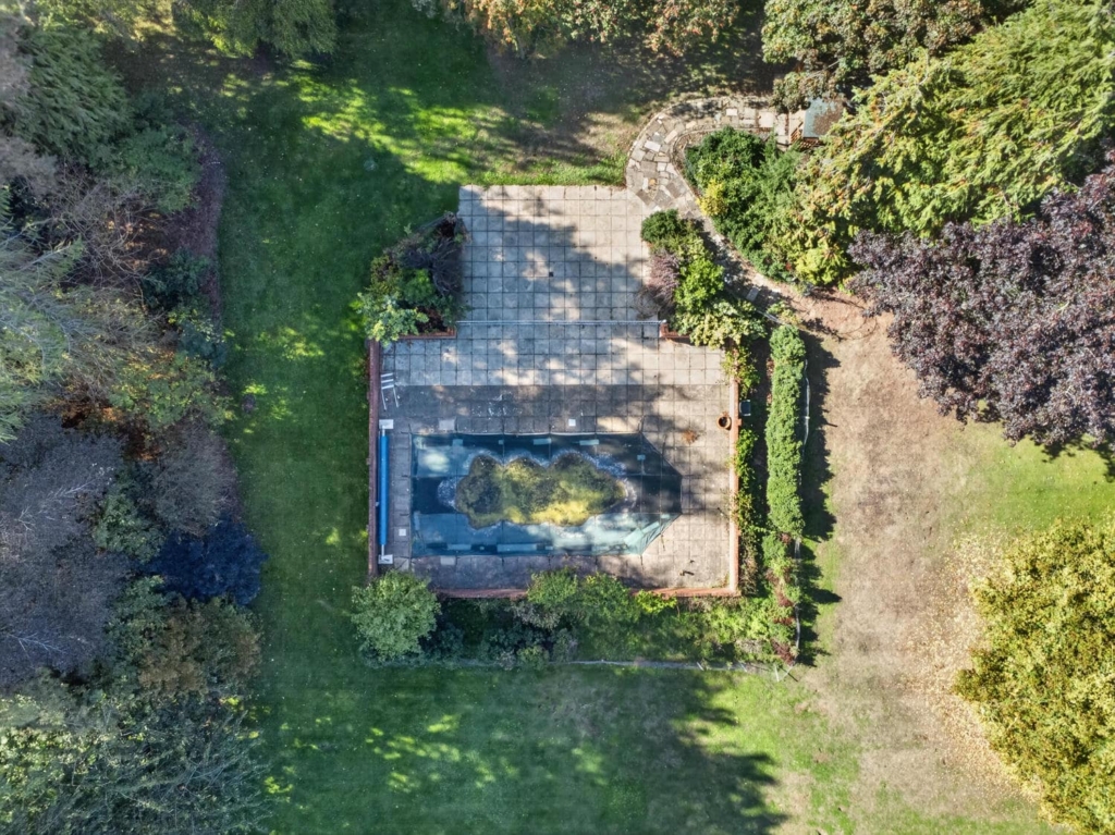 Aerial view of the walled swimming pool and terrace at Loddon Hall, Norfolk