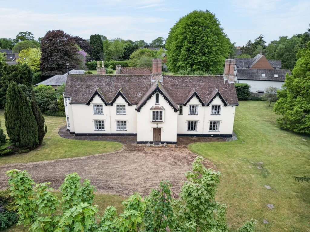 Aerial view of The Priory Suffolk showing front elevation, gabled roofline and surrounding gardens