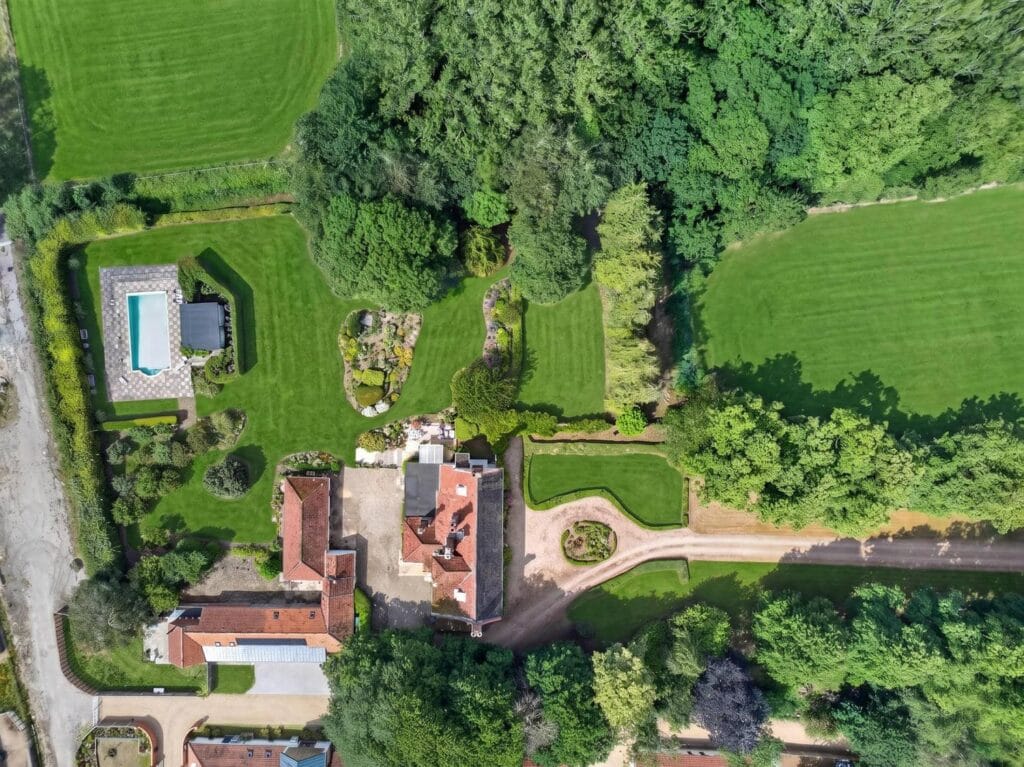 Aerial view of Bury's Hall Ashill grounds with pool, gardens and countryside