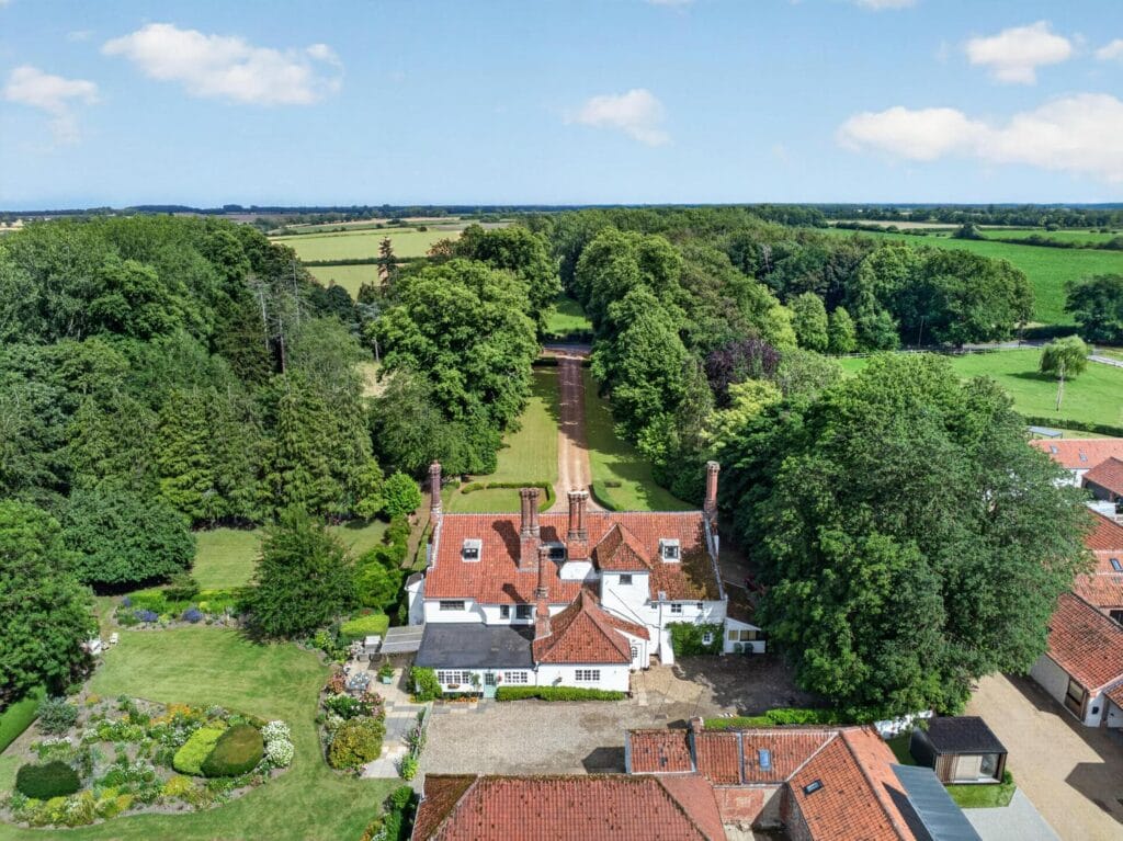 Wide aerial view of Bury's Hall estate set within Norfolk farmland