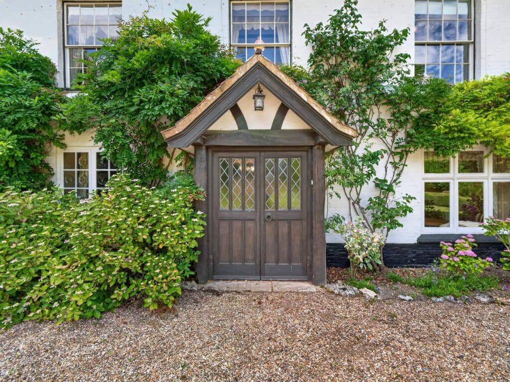 Bury's Hall Ashill entrance porch with oak door and climbing plants