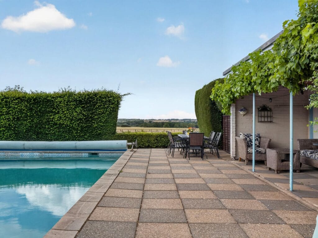 Bury's Hall Ashill outdoor swimming pool with terrace and countryside views