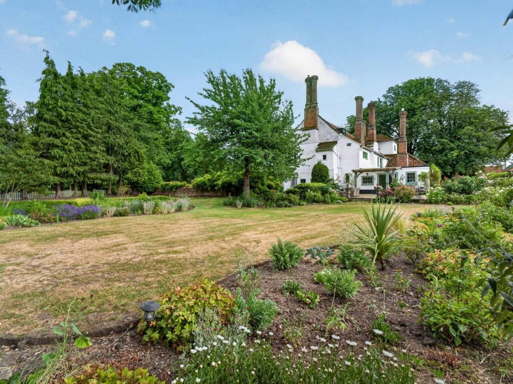 Bury's Hall Ashill rear exterior view across lawns and gardens