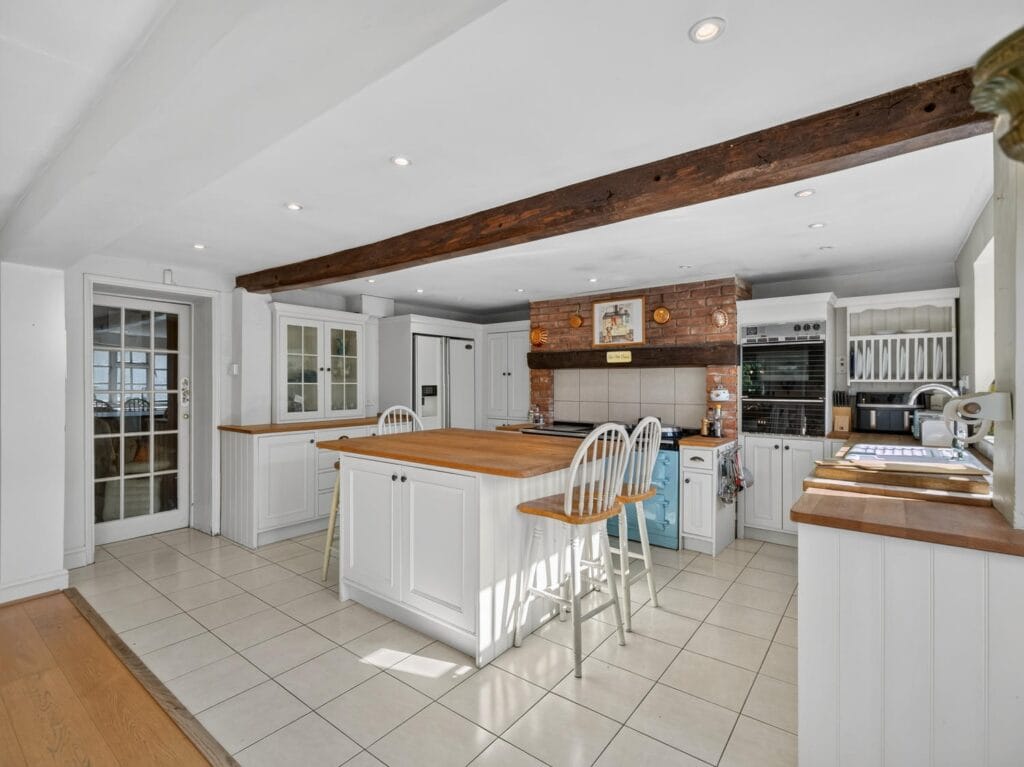 Large white kitchen with island and exposed beams, Bury's Hall Ashill