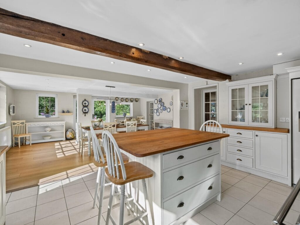 Open-plan kitchen with central island, oak worktop and garden views