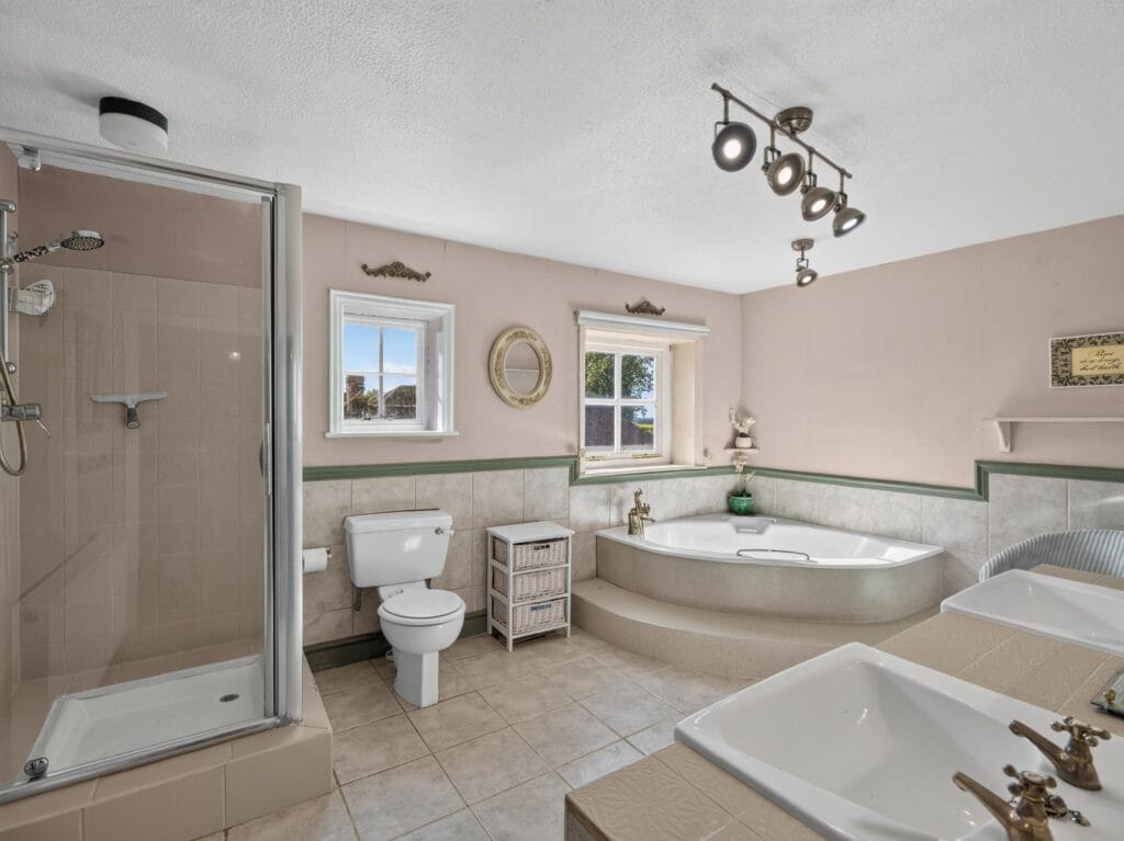 Luxury family bathroom with corner bath, shower and twin sinks
