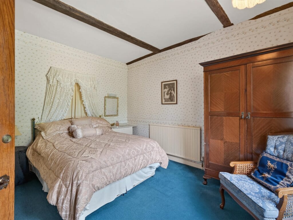 Bury's Hall Ashill double bedroom with oak wardrobe and blue carpet