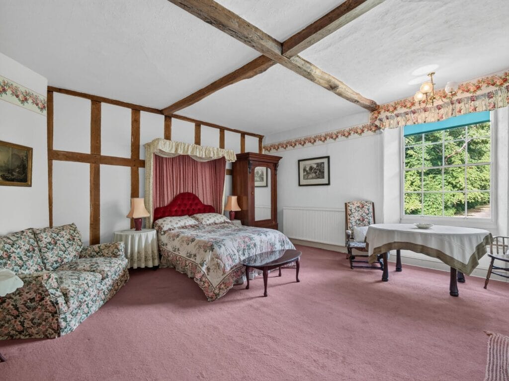 Bury's Hall Ashill bedroom with four-poster bed and beamed ceiling