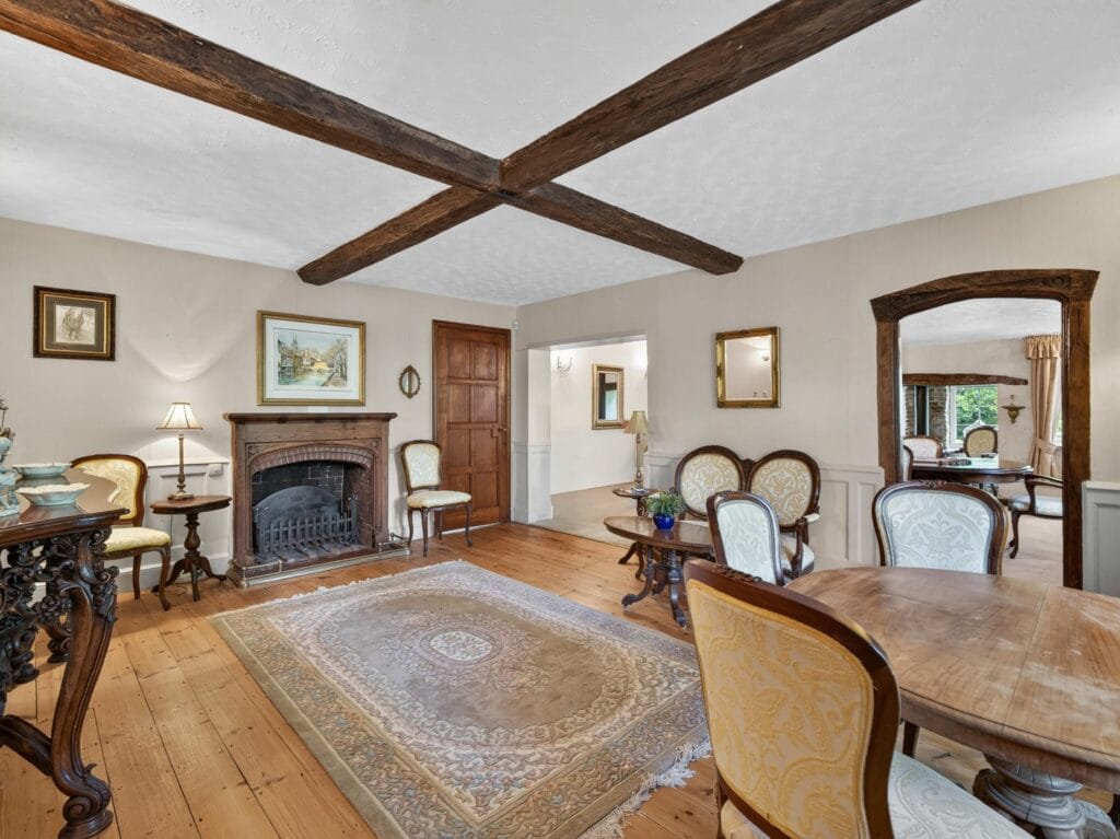 Elegant sitting room with coffered oak beams and period fireplace