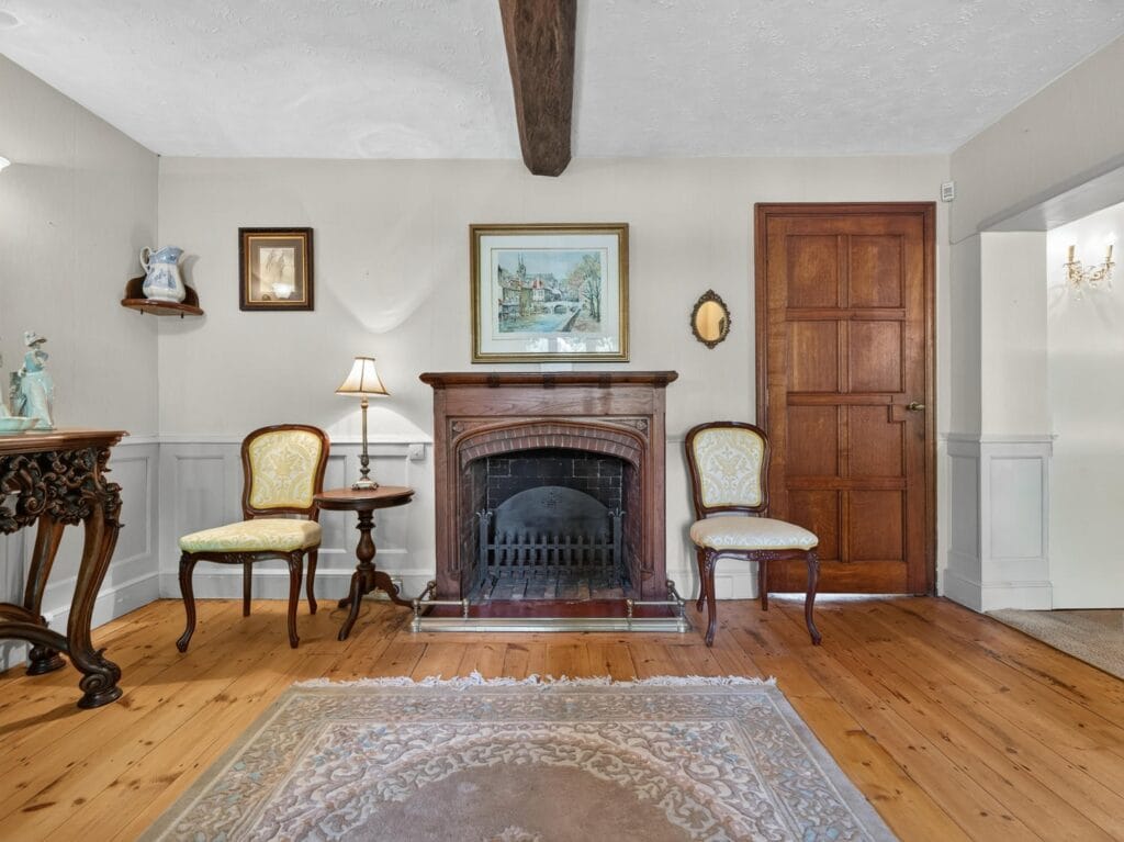 Reception room with original fireplace and polished hardwood floors