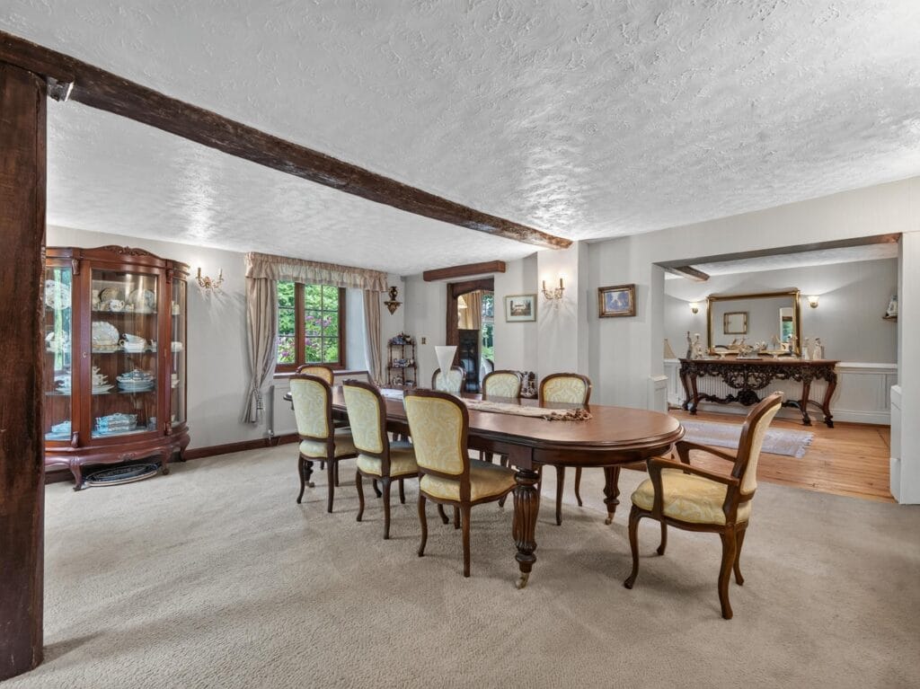 Bury's Hall Ashill formal dining room with oak beams and oval table