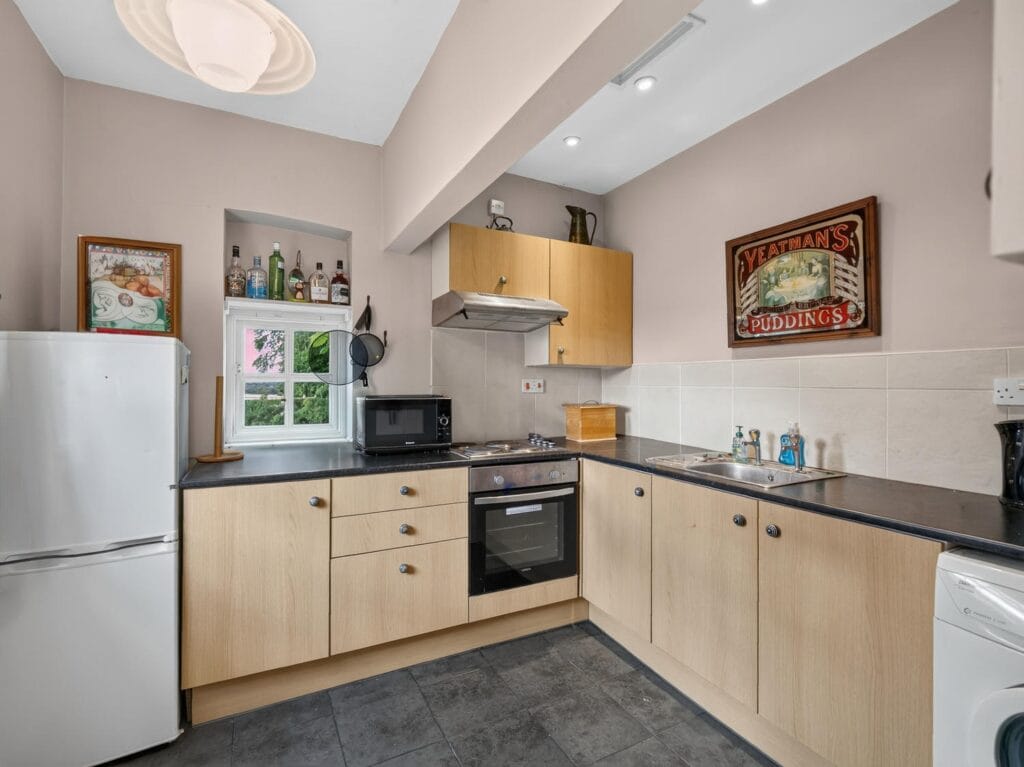 Bury's Hall Ashill fitted kitchen with wooden units and dark worktops