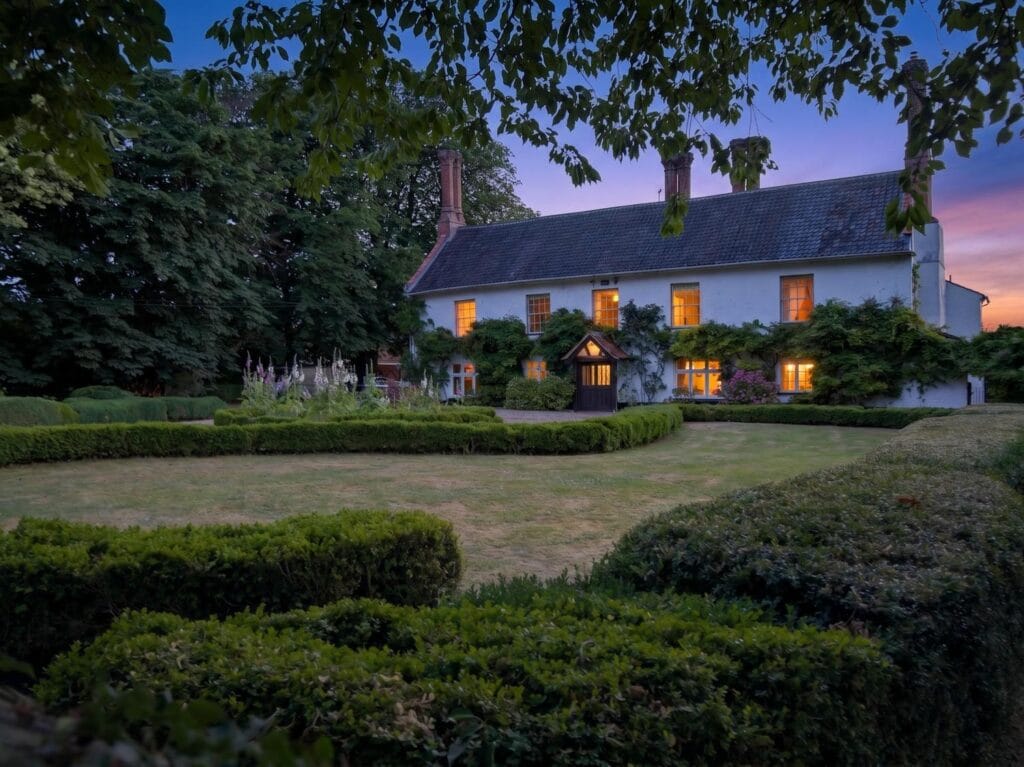 Bury's Hall Ashill rear garden with topiary hedges at dusk