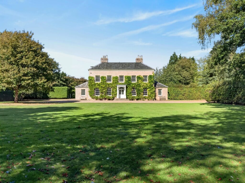 Loddon Hall Georgian country house for sale in Norfolk, seen across the front lawn