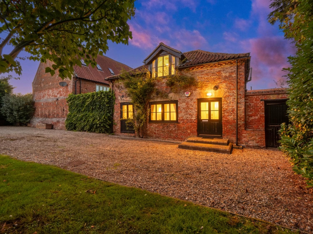 Stable Cottage at Loddon Hall at dusk, brick annexe with private yard, Norfolk