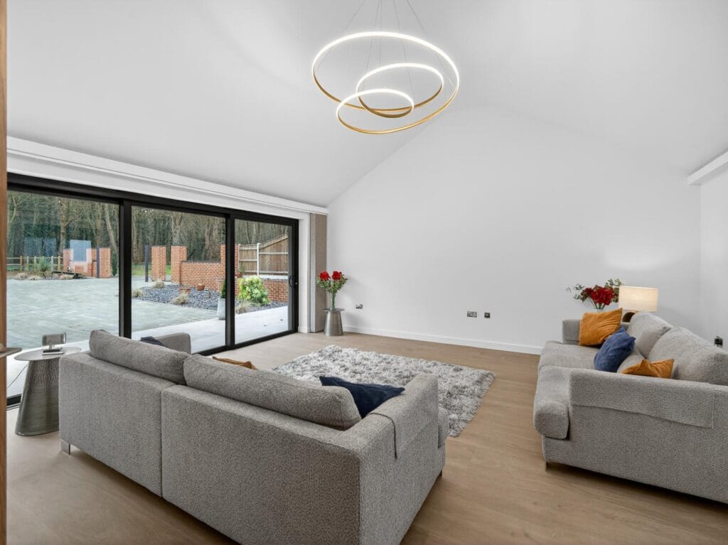 Elegant drawing room and media lounge with contemporary lighting, sliding doors and views to the private courtyard.