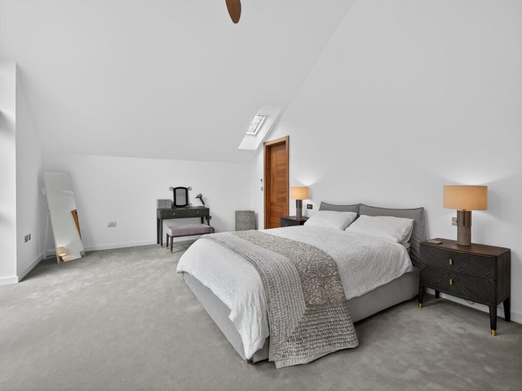 Large principal bedroom with vaulted ceiling, skylight, dressing area and access to ensuite bathroom.