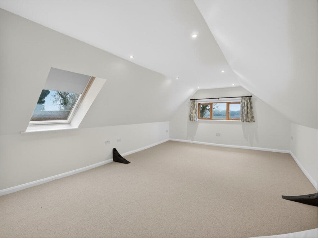 Large loft room with skylight