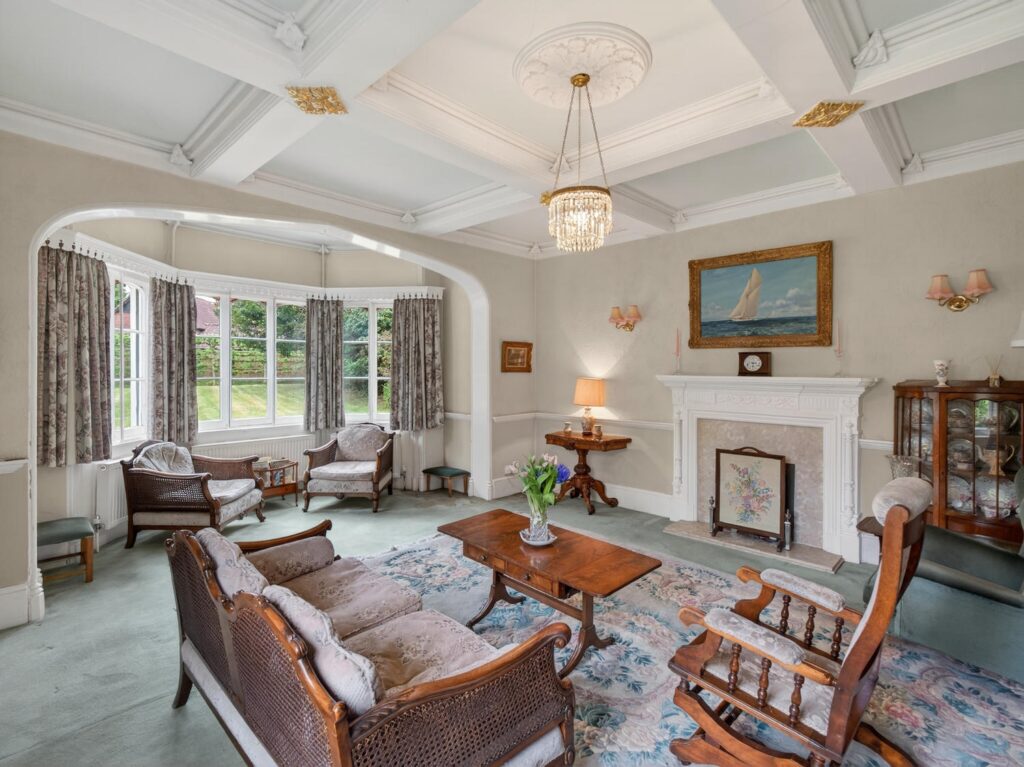 Drawing room at The Priory Suffolk with coffered ceiling, gilded ceiling bosses, bay window and carved fireplace