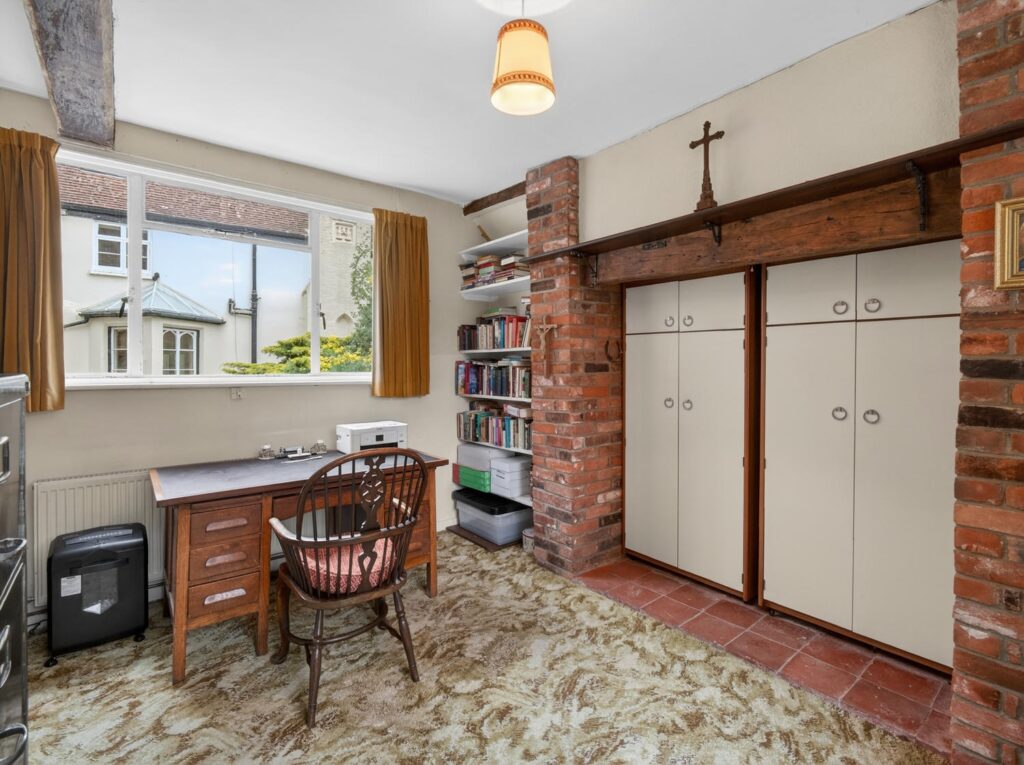 Study at The Priory Suffolk with exposed brick chimney breast, timber bressummer beam and quarry tile hearth