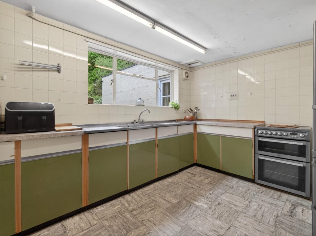 Kitchen at The Priory Suffolk with rear-facing window, generous footprint and L-shaped layout